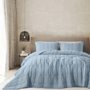 Sunwashed Storm Blue comforter set neatly styled on a queen bed with matching pillowcases

