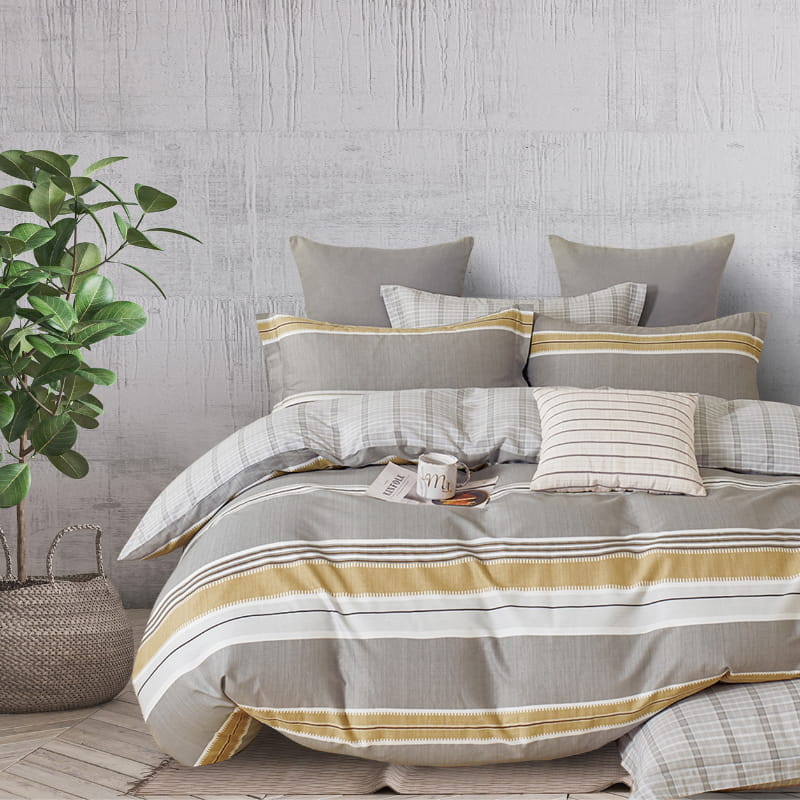 alt="Luxurious quilt cover set features stripe design and co-ordinating check reverse"