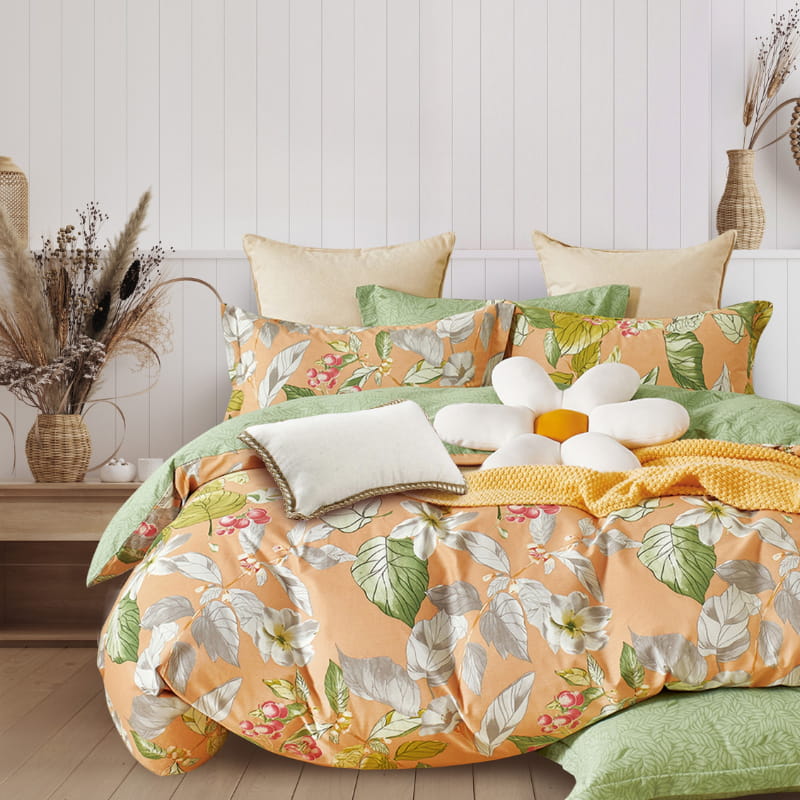 alt="Luxurious quilt cover set features lush flowers against a peach background"