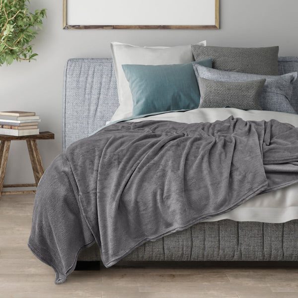 Transform your space into a cosy sanctuary with the charcoal Odyssey Living Super Soft Blanket, designed to complement your mood and décor with its harmonious colour scheme.