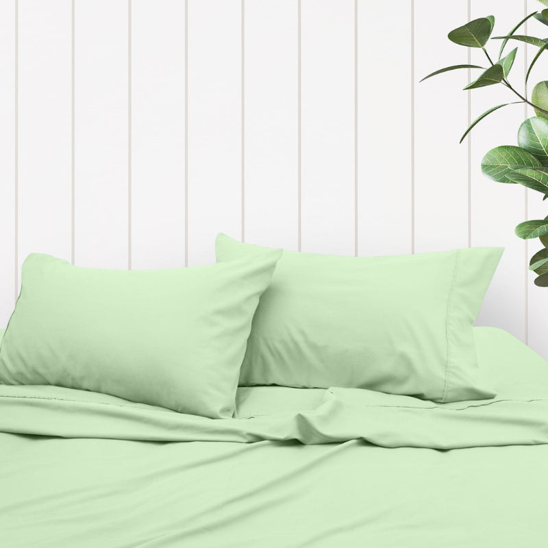 A clean and classic light green bed with matching sheets and pillows, made of 100% microfibre for a soft and warm feel.