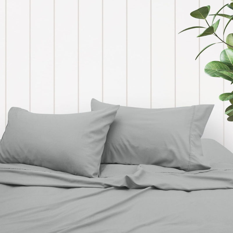 A clean and classic grey bed with matching sheets and pillows, made of 100% microfibre for a soft and warm feel.