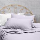 A clean and classic lilac bed with matching sheets and pillows on a cosy bedroom, made of 100% microfibre for a soft and warm feel.