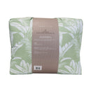 Packaging view of the Zanzibar Sunwashed Sage Comforter neatly layered on a bed