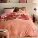 Oilily Livia Multi Quilt Cover on a bed with warm timber backdrop and candlelight