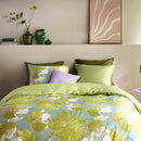 Oilily Melodi Green Quilt Cover Set styled on bed with olive and lilac cushions