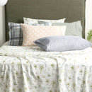 Styled bedroom with Park Avenue Capri Palm sheets paired with patterned pillowcases