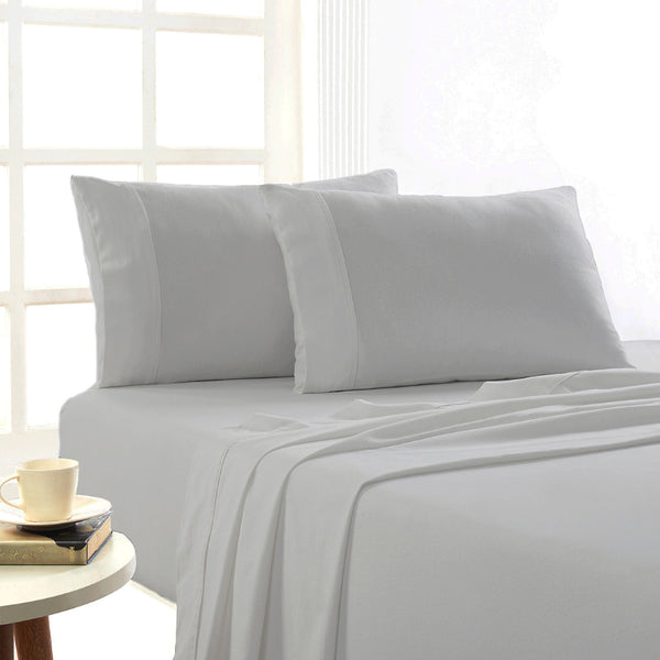 Silver Egyptian cotton flannelette sheets styled in a bright, cosy bedroom setting