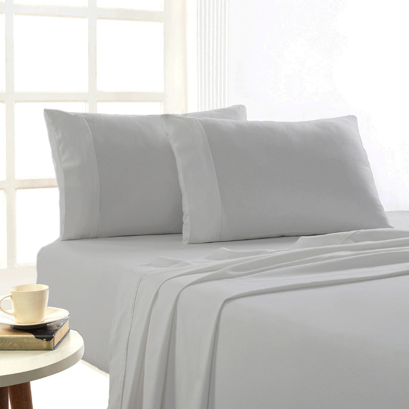 Silver Egyptian cotton flannelette sheets styled in a bright, cosy bedroom setting