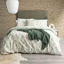 Gumnut print flannelette quilt cover set styled on a winter bed with soft green and blush eucalyptus leaves
