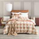 Bed styled with Park Avenue Twill Checks flannelette quilt cover and matching pillows in warm tones
