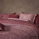 alt="Side view of an elegant Casa dei Fiori quilt cover with intricate floral designs, and a reversible print of tiny flowers."