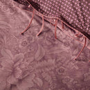 alt="An elegant Casa dei Fiori quilt cover with intricate floral designs, and a reversible print of tiny flowers with the back of pillow."