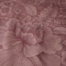 alt="Closer view of an elegant Casa dei Fiori quilt cover with intricate floral designs, and a reversible print of tiny flowers."