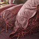 alt="Elegant Casa dei Fiori quilt cover with intricate floral designs, and a reversible print of tiny flowers with the pillows."