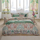 alt="Premium cotton quilt cover with ornate mirrored design and reversible foliage pattern in a cosy bedroom"