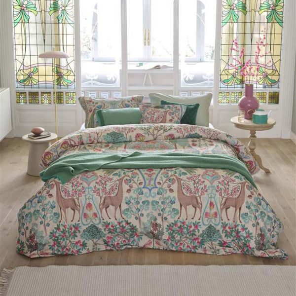 alt="Premium cotton quilt cover with ornate mirrored design and reversible foliage pattern in a cosy bedroom"