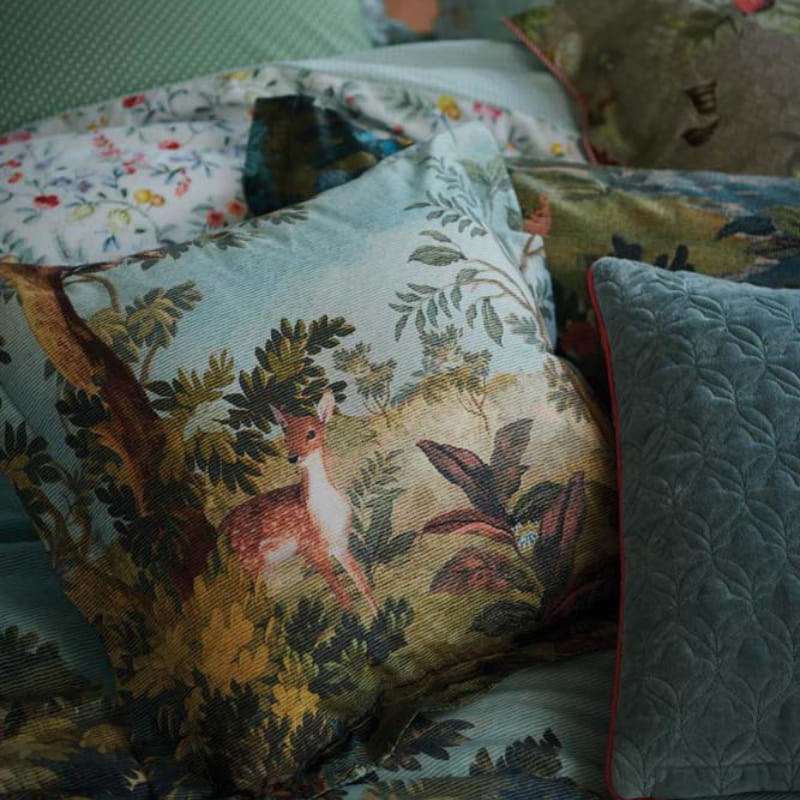 alt="Close up look of a decorative reversible filled cushion with rich plant and flower designs, made of 100% percale cotton with other cushions."