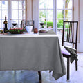 A beautifully set table adorned with a grey tablecloth, enhancing the elegance of the dining experience.