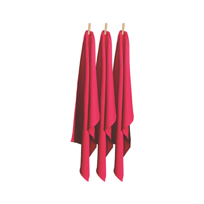 A trio of hot pink tea towels displayed on clothes pegs, emphasizing their absorbency and stylish appearance for kitchen tasks.