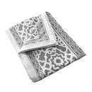 A stylish white and grey tablecloth adorned with a sophisticated pattern, perfect for adding elegance to your decor.