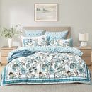 Renee Taylor Anaya quilt cover set styled on a bed with teal floral and paisley print