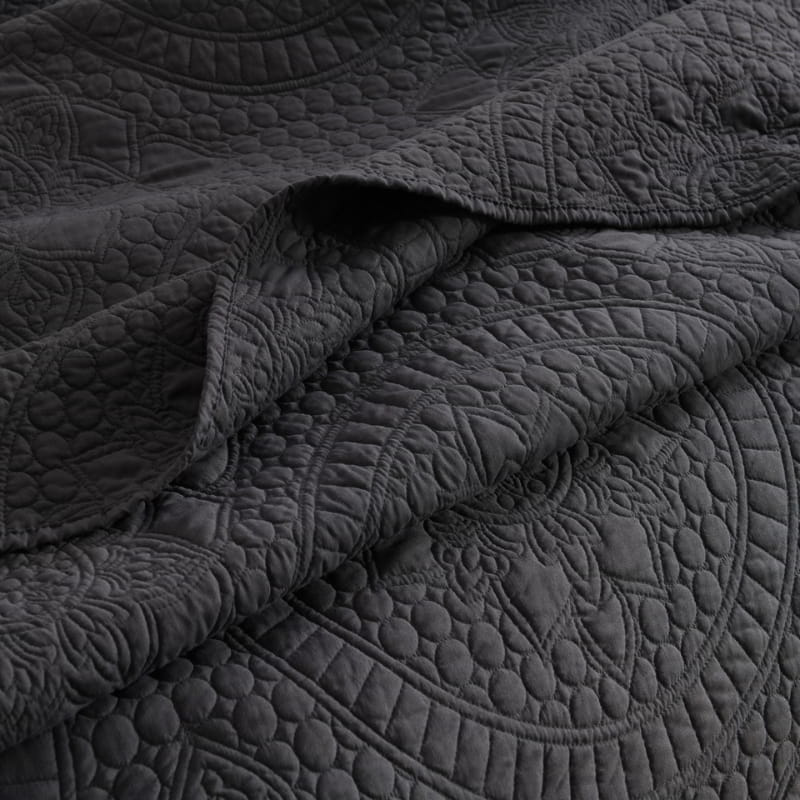 alt="Zoom in details of a grey quilt cover features an inspiration from the ornate detailing of traditional Greek tile patterns.