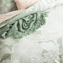 Exquisite bed adorned with a captivating green and white floral pattern, exuding elegance and charm.
