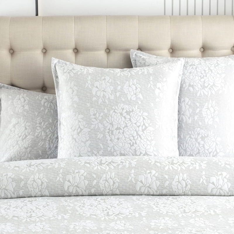 alt="Showcasing an ivory european pillowcase infused with blooming flower bundles"