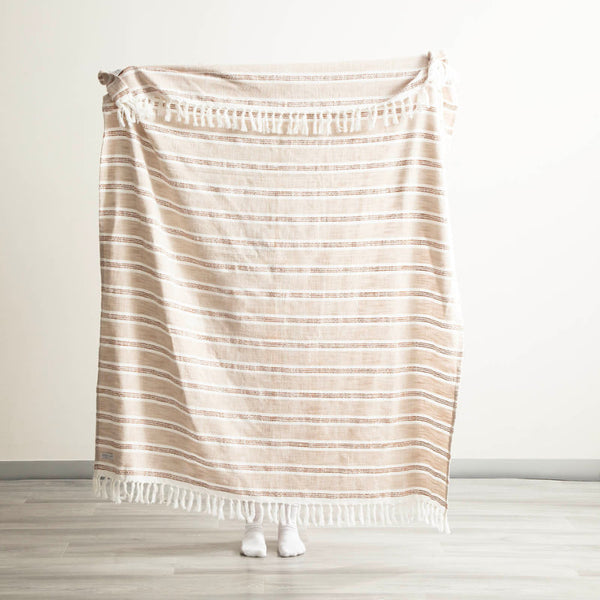 Renee Taylor Como Stripe Natural Throw held up to show full size and pattern