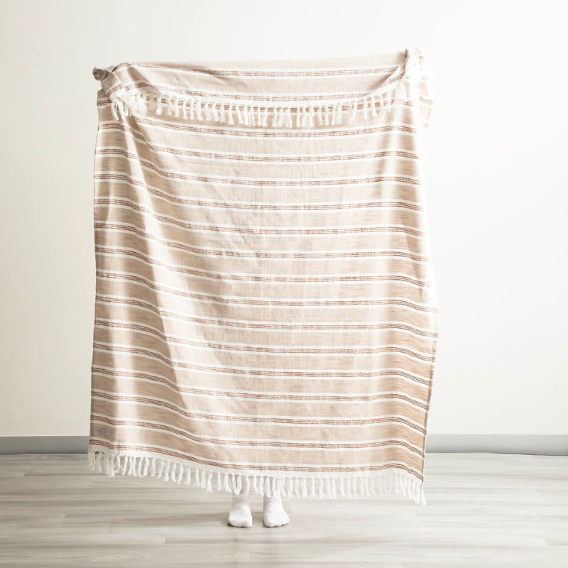 Renee Taylor Como Stripe Natural Throw held up to show full size and pattern