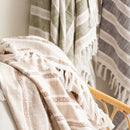 Close-up of Renee Taylor Como Stripe Natural Throw with fringe and stripe detail

