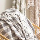 Close-up of Renee Taylor Onyx striped cotton throw with fringe on chair

