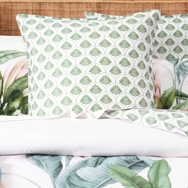 Gardenia European Pillowcase in soft green botanical print on a made bed

