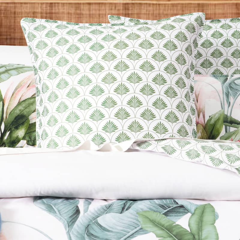 Gardenia European Pillowcase in soft green botanical print on a made bed


