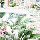 Close-up of botanical cotton fabric with soft pink proteas and lush green leaves

