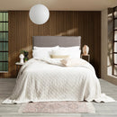 A cozy bedroom featuring silver line colour ultra soft velvet blanket with a diamond pattern and clean edge.