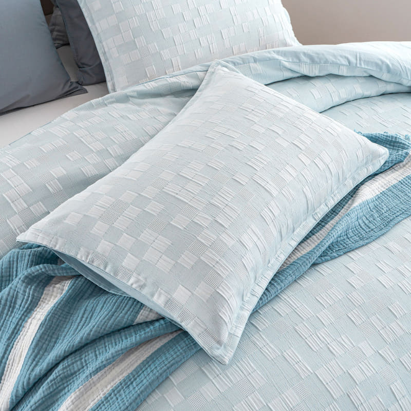 alt="Zoom in details of a French blue quilt cover set designed with delicate quilting texture and is pleasant to the touch with the pillowcases."