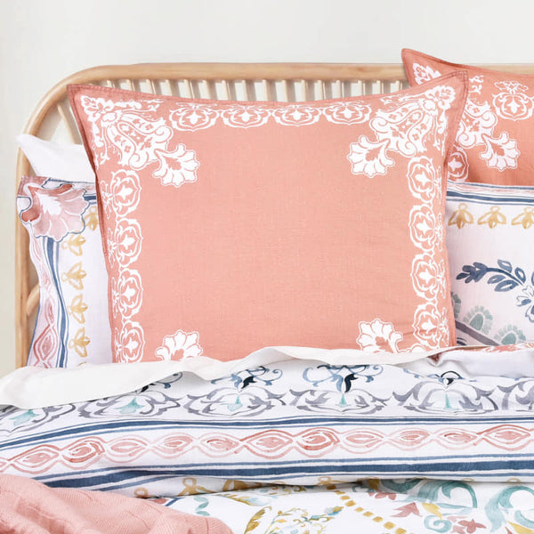 Close-up of Renee Taylor Kalina European pillowcase in rust with white floral border

