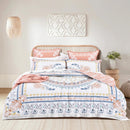 Renee Taylor Kalina quilt cover set styled on a bed with warm florals and terracotta accents