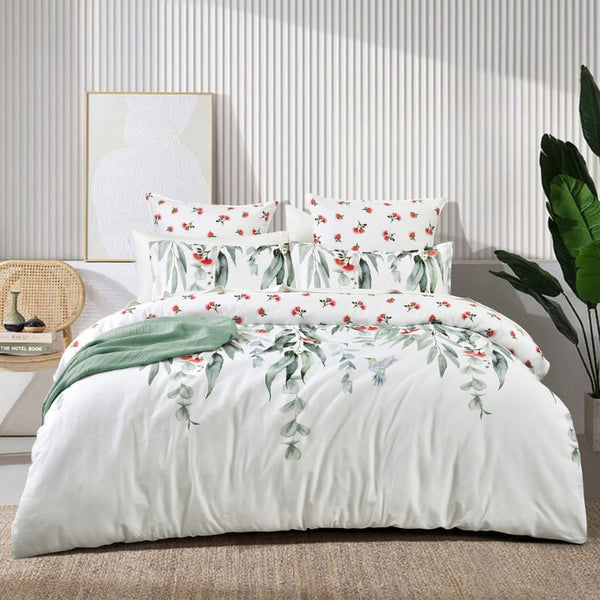 Bedroom view of Mallees quilt cover styled with soft green throw and layered pillows