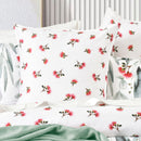 European pillowcases with matching native floral print on a made bed
