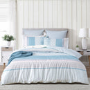 Full bedroom view of Margot quilt set with soft blue tones and mixed patterns