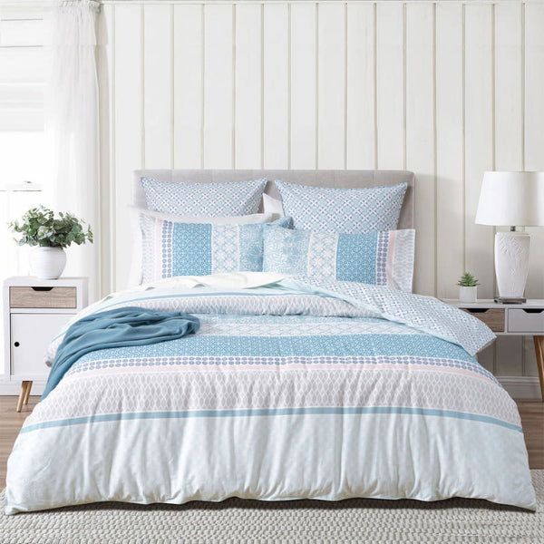 Full bedroom view of Margot quilt set with soft blue tones and mixed patterns