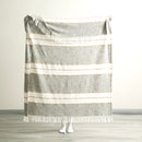 Full size of the Modena Stripe Sage Throw held up to show generous dimensions and relaxed drape