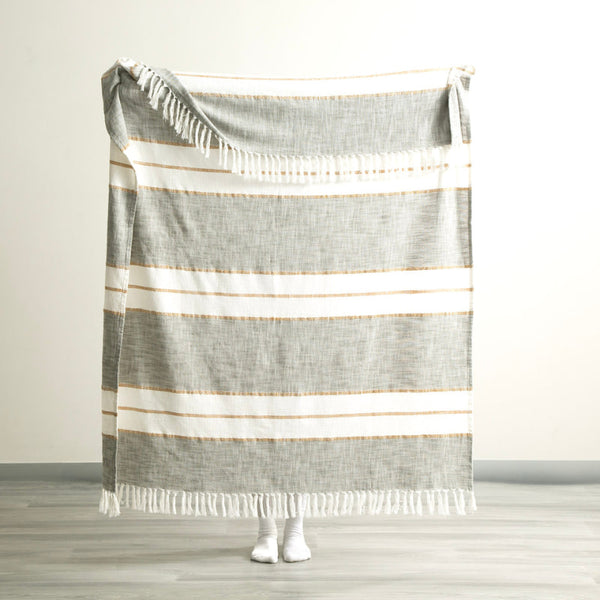Full size of the Modena Stripe Sage Throw held up to show generous dimensions and relaxed drape