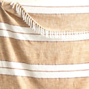 Close-up of the tan and white striped throw with fringe edge detailing