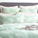 Exquisite bed featuring green and white bedding, highlighting the serene charm of the european pillowcase.