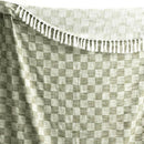 Close-up of the two-tone jade check pattern and fringe detailing