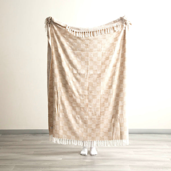 Full-size nude throw held open to show generous size and fringe edging.